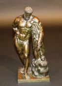 A 19th Century Continental bronze figure of the Farnese Hercules with club, 37 cm high, raised on