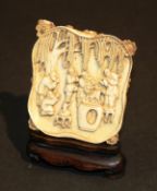 A 19th Century Chinese carved ivory panel depicting figures in a garden with dog of fo, decorated