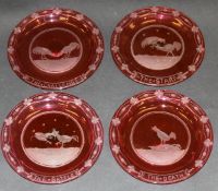 A set of four 19th Century cranberry glass plates etched with cock fighting scenes after Henry Alken