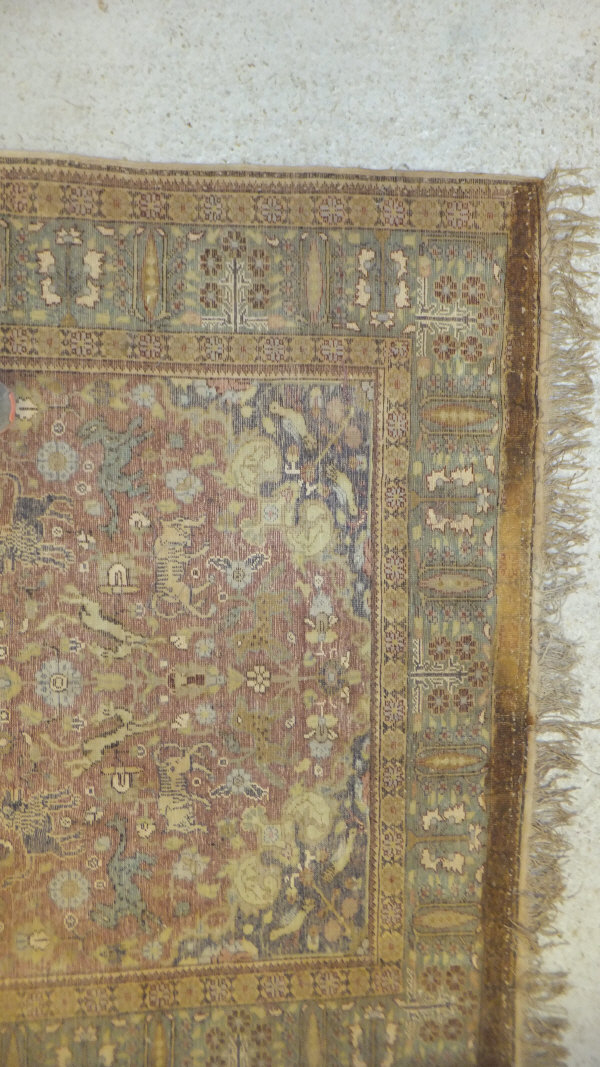 A Persian carpet, the central panel set with a floral decorated medallion on a brown ground with - Image 2 of 10