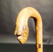 A 19th Century walking stick with parquetry ware banding, the handle terminating in carved monkey