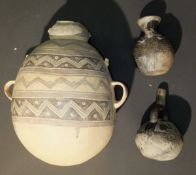 A Peruvian Chimu style pottery two handled bottle with zigzag and dot decoration, 36 cm high,