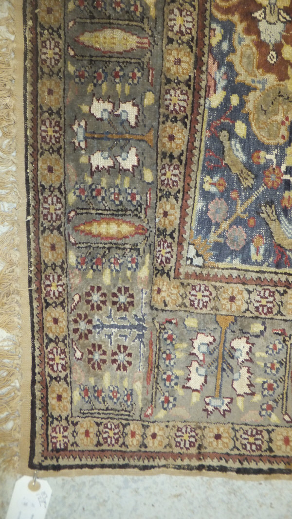 A Persian carpet, the central panel set with a floral decorated medallion on a brown ground with - Image 7 of 10