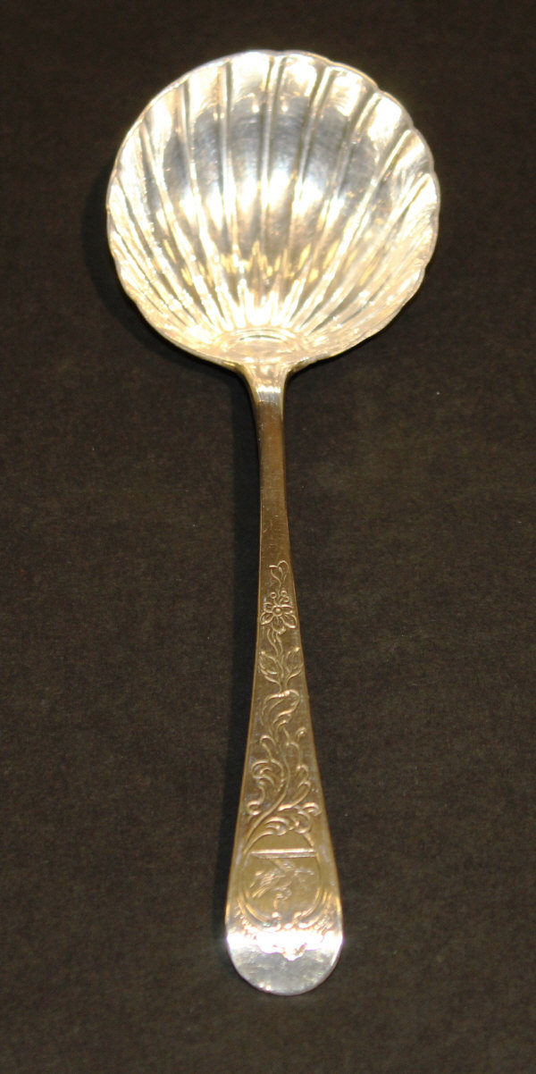 A George III silver Old English pattern ladle with floral engraved handle and armorial depicting a