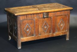 A circa 1700 oak coffer, the quartered panel top opening to reveal a candle box over a notch