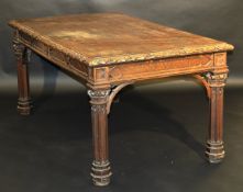 A Victorian oak library table in the Gothic Revival taste, the plain top with foliate carved edge