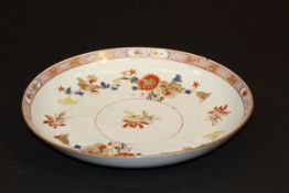 A 19th Century Chinese export ware dish, the centre field polychrome decorated with floral sprays