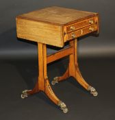 An early 19th Century mahogany games table of Pembroke style, the top with sliding cover and