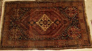 A Caucasian rug, the central panel set with cream medallion and geometric patterns on a red and blue
