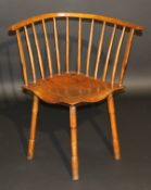 An early 19th Century West Country ash and elm corner chair, the bowed top rail on turned spindles