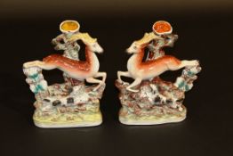 A pair of 19th Century Staffordshire pottery spill vases as a running stag and hound, 18 cm