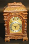 A Victorian carved oak cased mantel clock, the eight day two train musical movement with brass