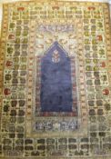 A Persian silk rug, the central panel set with blue Mirab design within a stepped pale cream, sage