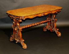 A Victorian walnut centre table, the rounded rectangular top with moulded edge above a curved frieze