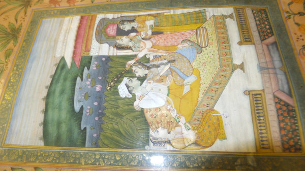 19TH CENTURY MOGHUL SCHOOL "Two lovers on a daybed in a courtyard with attendants", within an - Image 8 of 11