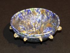An early marbled glass bowl of semi-spherical glass form with applied marbled glass loop