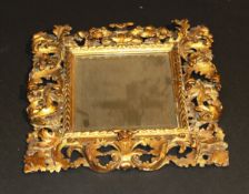 A 19th Century Florentine carved giltwood framed wall mirror of scrolling acanthus design, enclosing