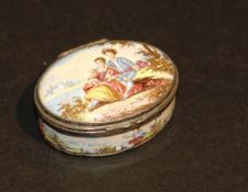 A 19th Century Bilston  style enamel style patch box of oval form depicting a young couple in 18th
