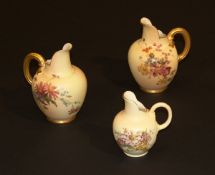 A pair of late Victorian Royal Worcester blushware jugs with floral spray decoration and gilt