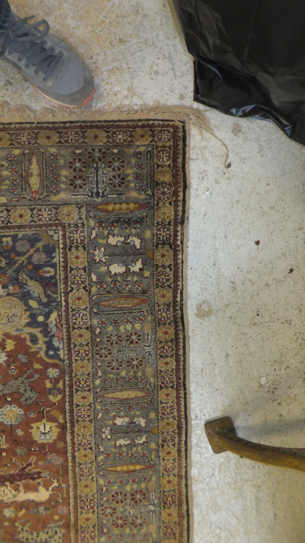 A Persian carpet, the central panel set with a floral decorated medallion on a brown ground with - Image 8 of 10