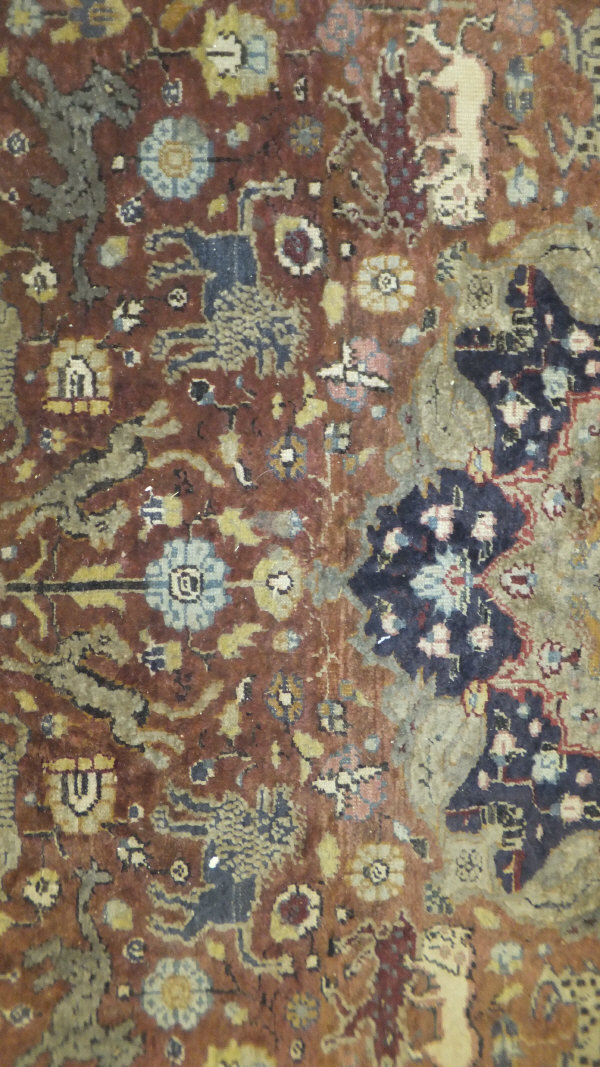 A Persian carpet, the central panel set with a floral decorated medallion on a brown ground with - Image 6 of 10