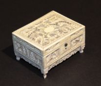 A late 19th / early 20th Century Chinese carved ivory lidded box with pierced decoration depicting