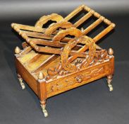 A Victorian rosewood four section Canterbury with wreath decoration in the manner of Loudon over a