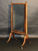 A late Regency mahogany cheval mirror, the rectangular plate on tapering turned column supports to