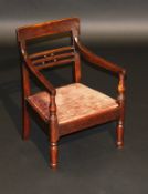 A William IV East Anglian mahogany child's bar back open arm elbow chair, the swept arms on baluster