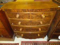 A Victorian mahogany bow fronted chest of two short and three long graduated drawers on turned feet