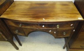 A Victorian mahogany bow fronted three drawer sideboard on square tapering legs to spade feet