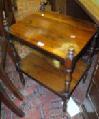 A 19th Century rosewood two tier whatnot on turned and ringed supports to brass castors