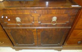 An early 19th Century mahogany secretaire, the fall front enclosing a basic fitted interior over two