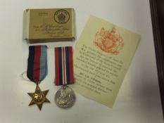 A 1939/45 War medal and a Defence medal in box, together with a certificate for GNR. R. H Humphreys