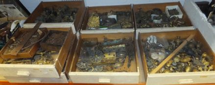 A collection of eight drawers of various door furniture, keys, castors, etc