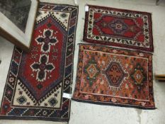 A Caucasian rug, the two central star shaped medallions on a red ground within a green, blue, red