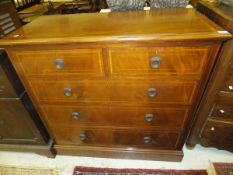 An Edwardian mahogany and inlaid chest of two short and three long graduated drawers on a plinth