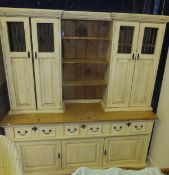 A cream painted pine dresser, together with a pale green painted pine wall shelf unit