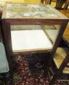 A Jeremy Green glass topped square display cabinet on square tapering supports in the Arts and