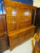 A yew wood display cabinet with glazed doors enclosing three shelves either side of the fall front