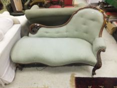 A Victorian walnut framed chaise longue, upholstered in pale green moire style fabric