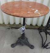 A Victorian cast iron based red marble topped circular pub style centre table