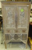 A two door Oriental style cabinet with a limed effect finish, together with a modern lacquered