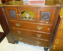 A mahogany chest of three drawers with three cupboard doors above in the Victorian manner