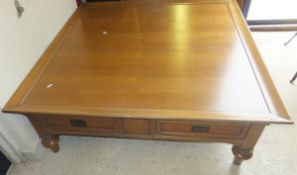 A large square reproduction coffee table with two frieze drawers, raised on turned and ringed legs