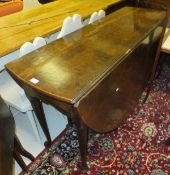 A circa 1800 oval drop-leaf table with end drawer on turned tapering legs to pad feet