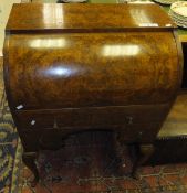A walnut cylinder top desk, the shaped top over four various drawers to hipped legs and pad feet