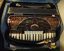 A Ranco Antonio Superbox accordion with black and red decoration with inset rhinestones, housed in a