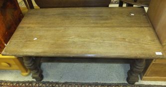 An oak rectangular coffee table with stretchered base and turned legs