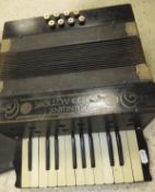 A "Genuine Piano Action" accordion, housed in an associated black plastic box